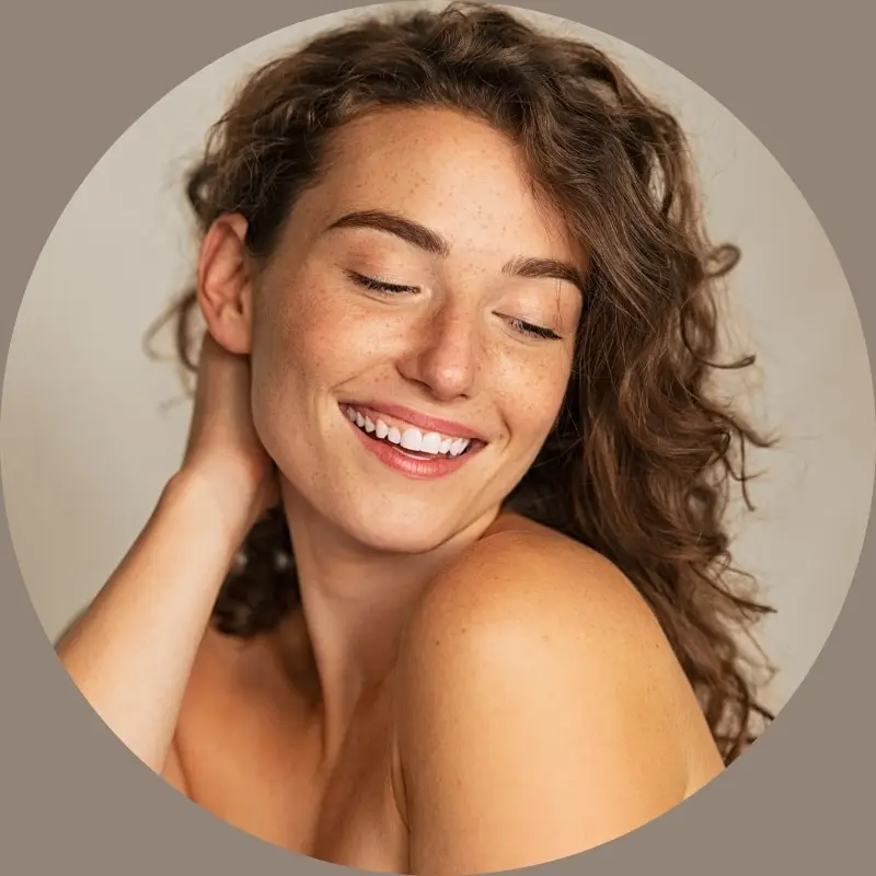 Woman with radiant healthy skin after organic facial treatment at The Knotstop spa in San Diego