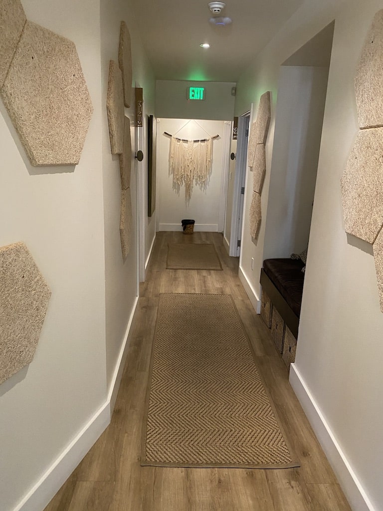 Interior corridor leading to private massage and skincare treatment rooms at The Knotstop spa in San Diego's Bankers Hill neighborhood.