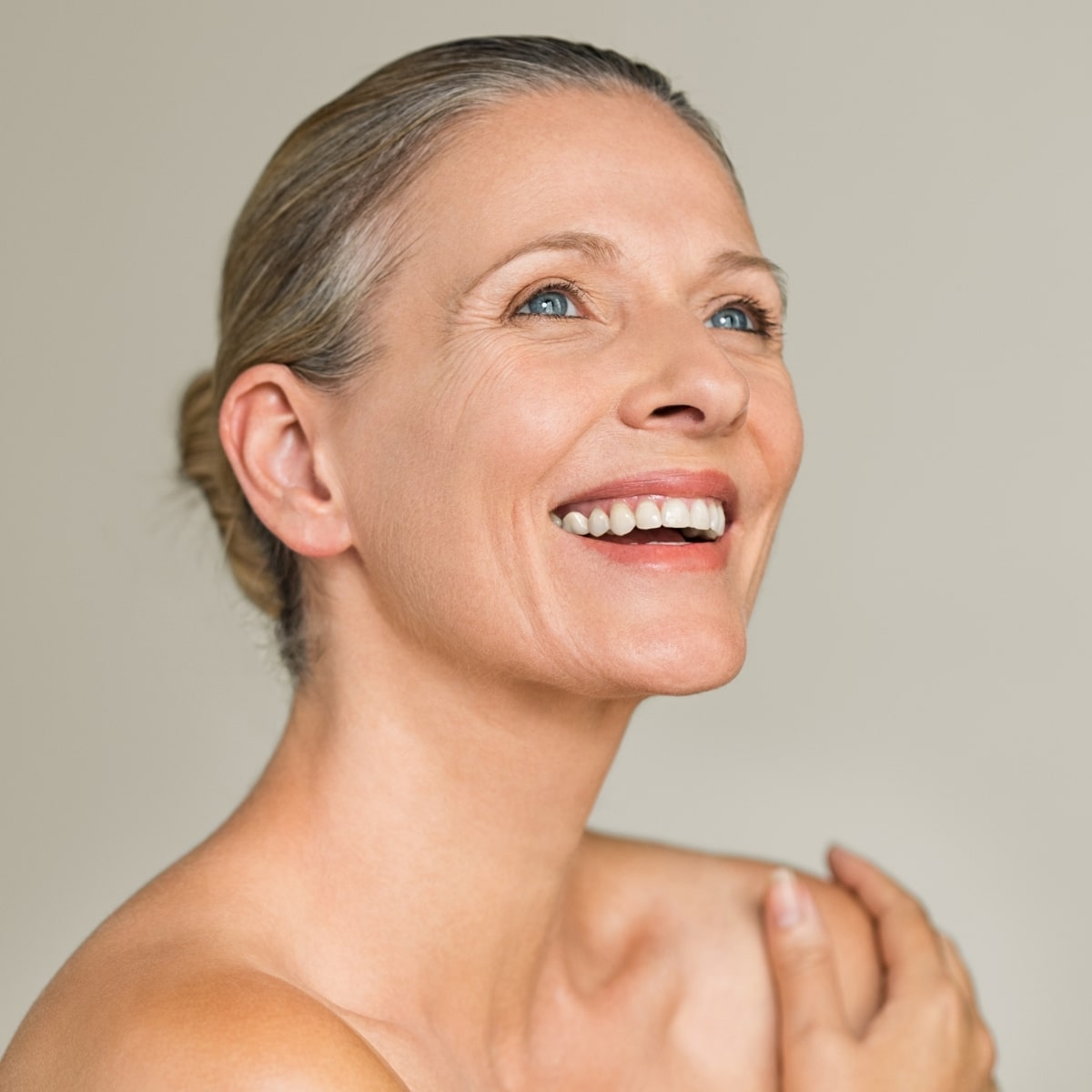 Smiling mature woman with healthy-looking skin